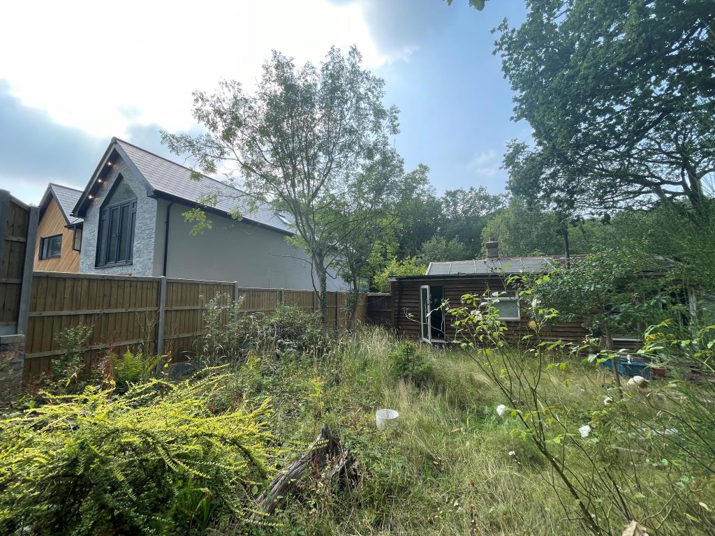 Lot: 82 - DETACHED BUNGALOW WITH POTENTIAL FOR REDEVELOPMENT - Rear view showing adjacent development
